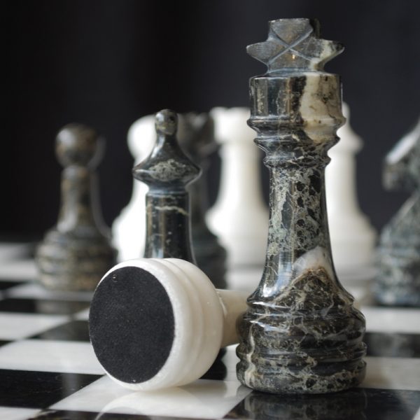 Timeless Chess Sets Collection featuring black and white chess pieces on a classic board.