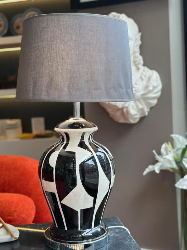 Black and White Abstract Ceramic Table Lamp – Modern Artistic Design featuring glossy ceramic base and gray fabric shade.