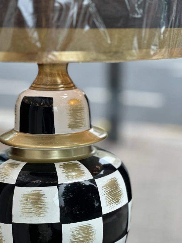 Black and gold checkered ceramic table lamp with glossy black and gold accents and matching lampshade.