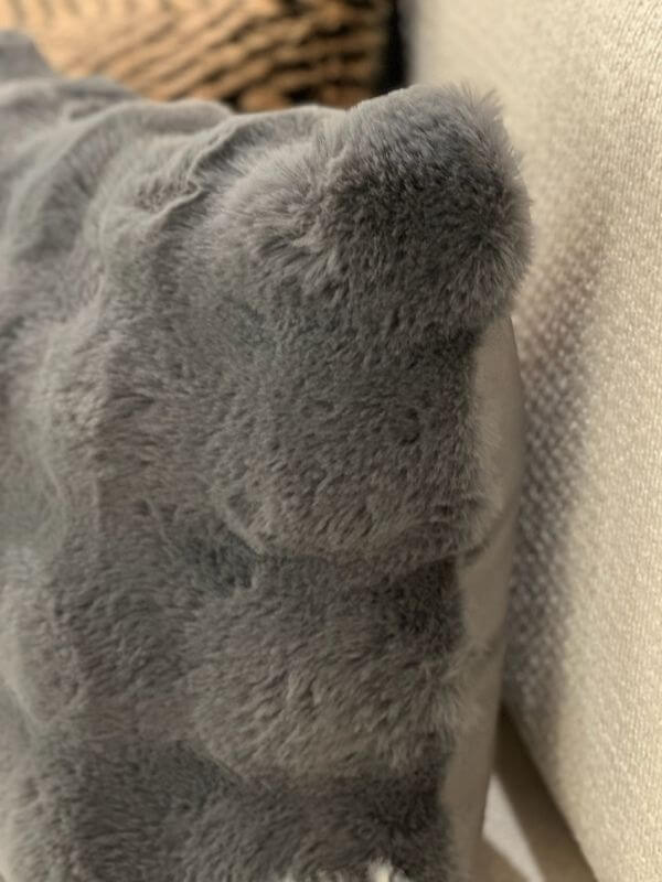 Close-up of an anthracite faux fur pillow case, showcasing its soft plush texture and cozy appearance.
