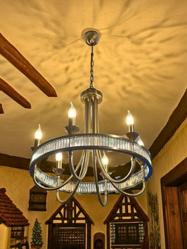 Modern Round Crystal Chandelier featuring a sleek design and sparkling crystals illuminating a warm space.