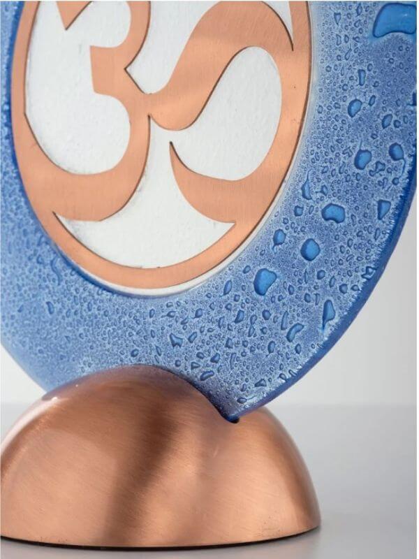 Copper glass sacred geometry decor object with OM symbol and blue glass design, ideal for home decor.
