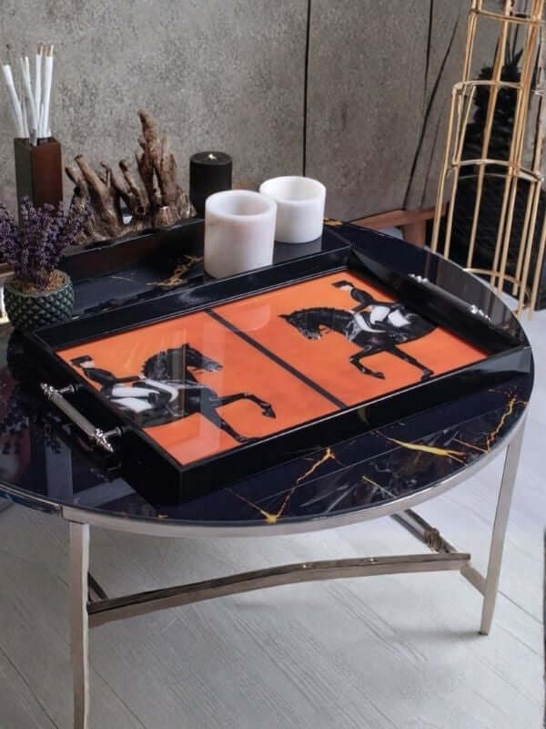 Horse design glass serving tray on a stylish coffee table with vibrant orange and horse motif.