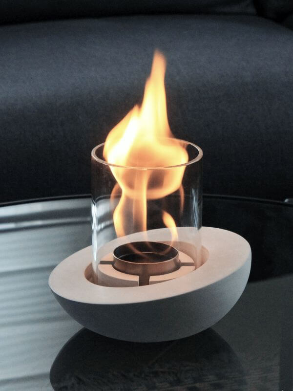 Decorative glass concrete fireplace with flame, elegant modern design for stylish interiors.