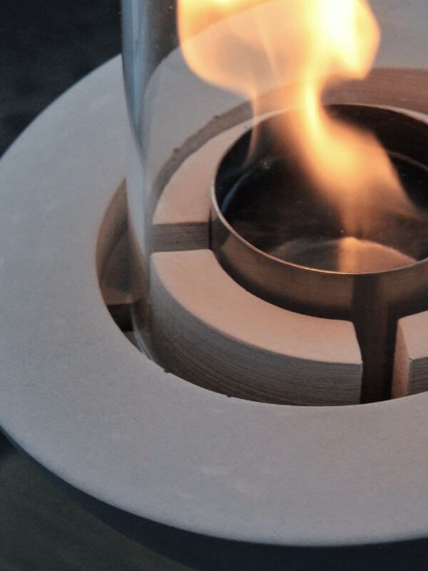 Close-up of a decorative glass concrete fireplace flame, showcasing the elegant design and modern functionality.