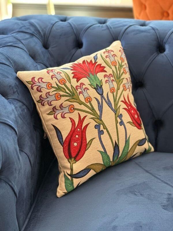 Ottoman tulip bloom cushion 41x41 cm on a blue tufted sofa, featuring vibrant floral designs and organic cotton fabric.