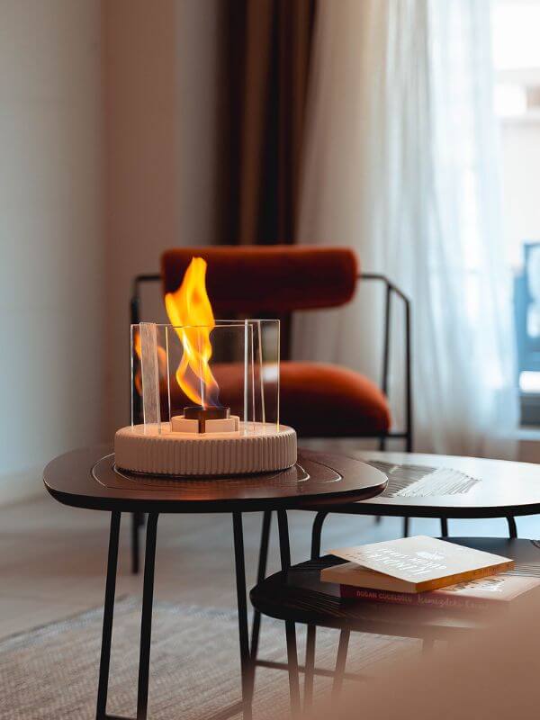 Modern concrete fireplace accent with vibrant flames in a contemporary living space.