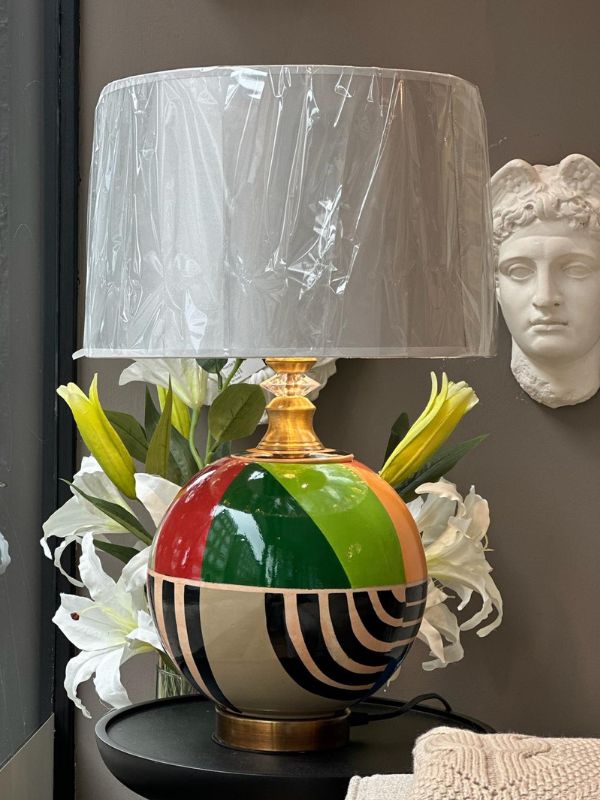Round multicolor ceramic table lamp with fabric shade and gold accents