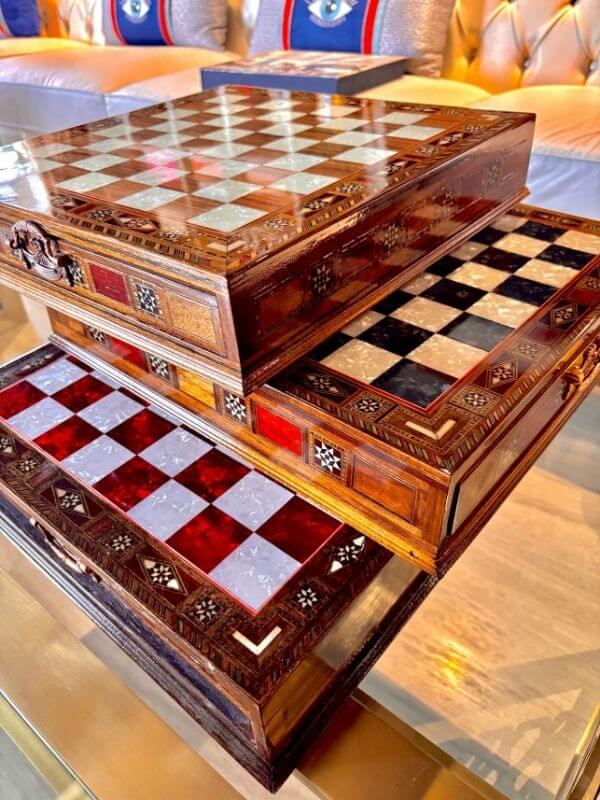 Large handmade chess set featuring beautifully crafted wooden boards and intricate designs.