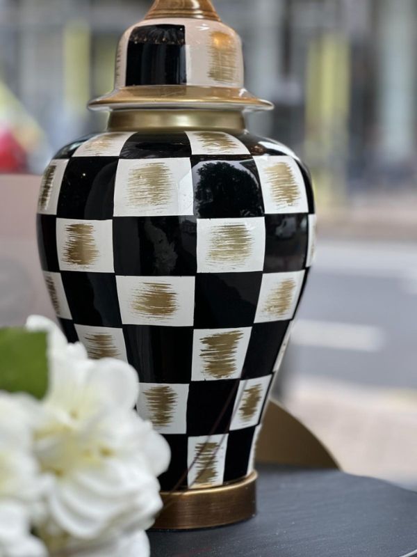 Black and gold checkered ceramic table lamp showcasing elegant design and glossy finish.